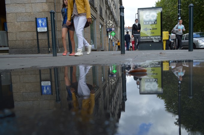 Reflection of the city in a puddle of rain
