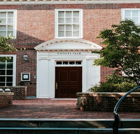 Historic brick building with colonial-style entrance on a Greater Boston university campus.