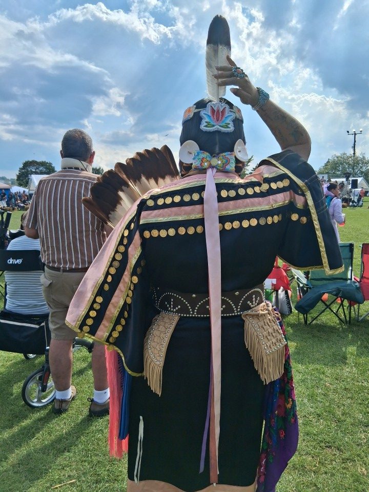 Dancers performing as other participants in regalia watch from the sidelines — Akwesasne International Powwow, Sept. 13, 2026, Lamoureux Park, Cornwall, Ontario, Canada