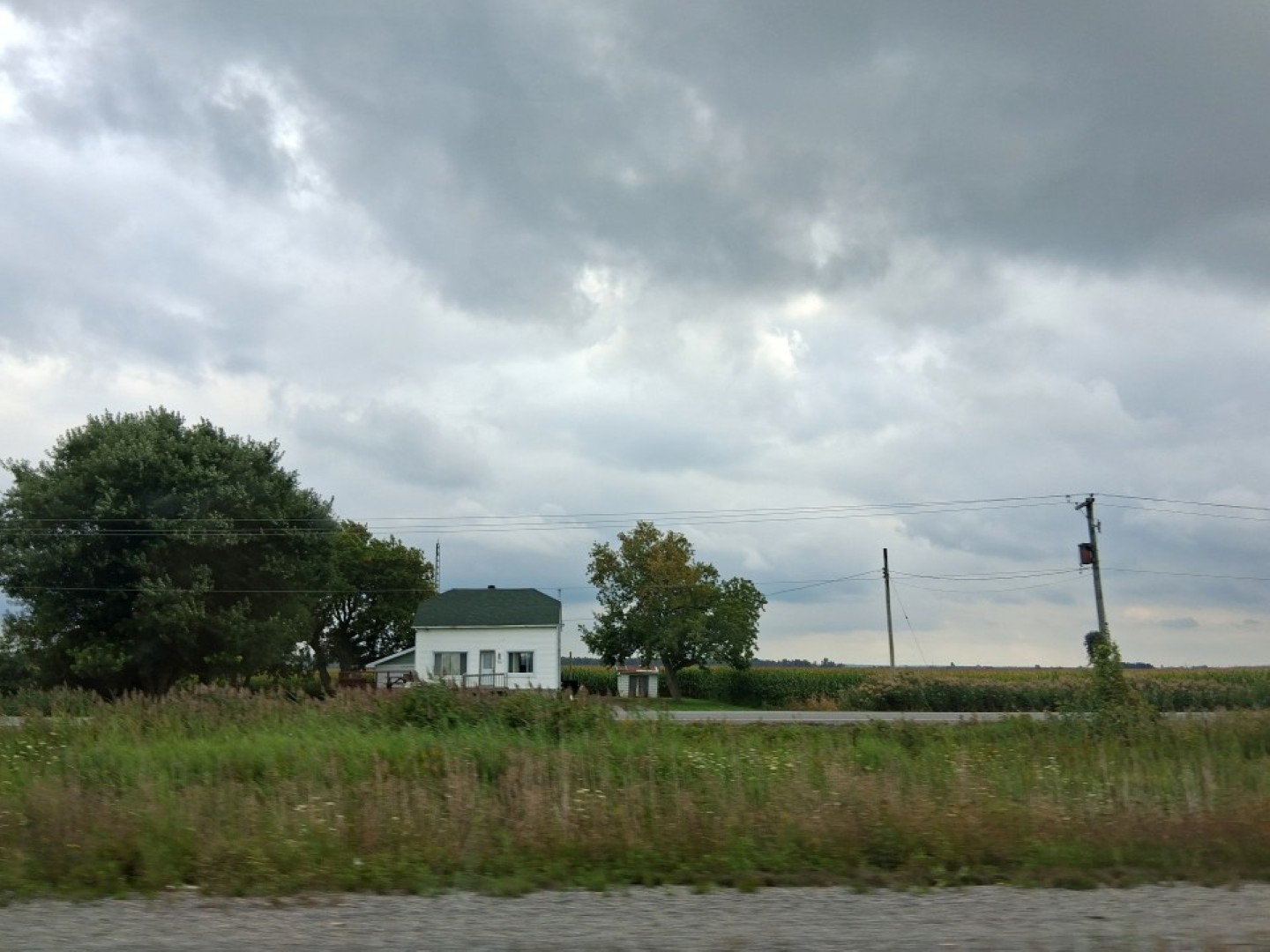 A house surrounded by fields in rural Eastern Ontario