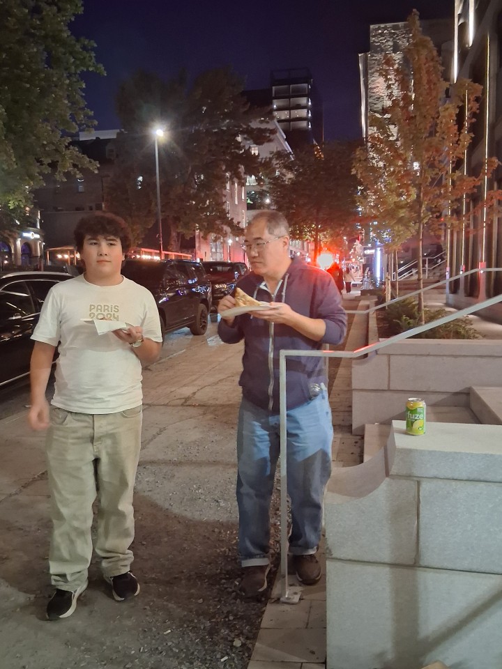 ... and then pizza, because the guys were still hungry after pasta, Sainte-Catherine Street before the concert — Oct. 3, 2026, Montreal, Quebec, Canada