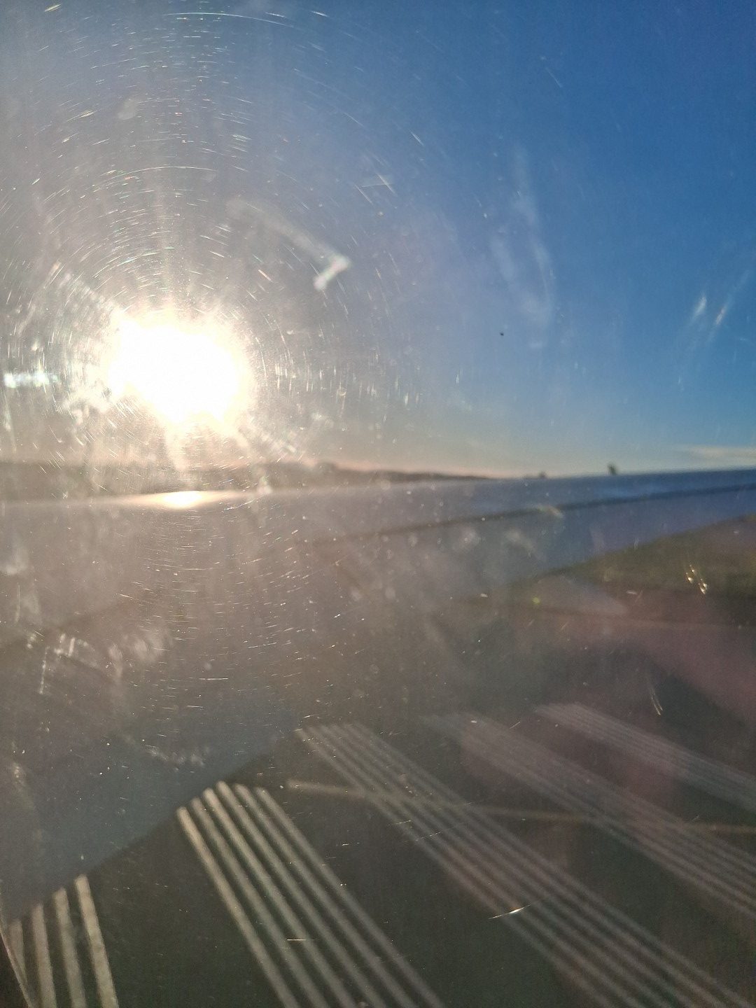 Late-afternoon sunshine through the airplane window — Oct. 17, 2026, Ottawa Macdonald-Cartier International Airport, Ottawa, Ontario, Canada