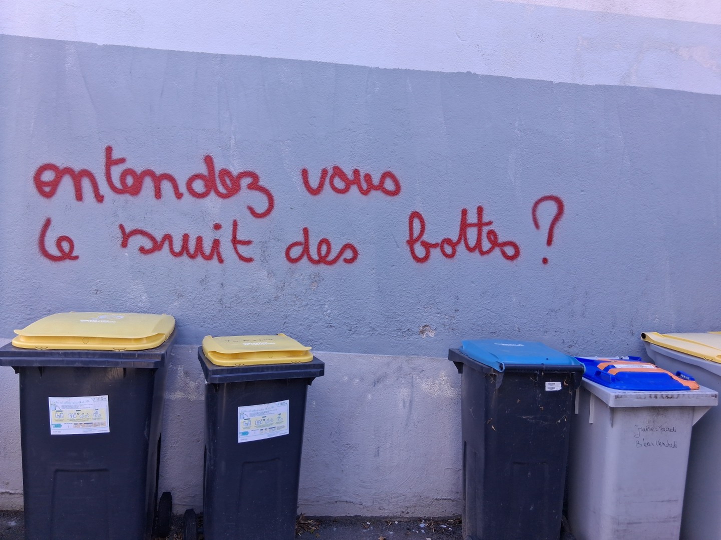 Can you hear the jackboots? Graffiti above a row of garbage bins — Oct. 21, 2026, Rue d’Allonville, Nantes, Pays de la Loire, France
