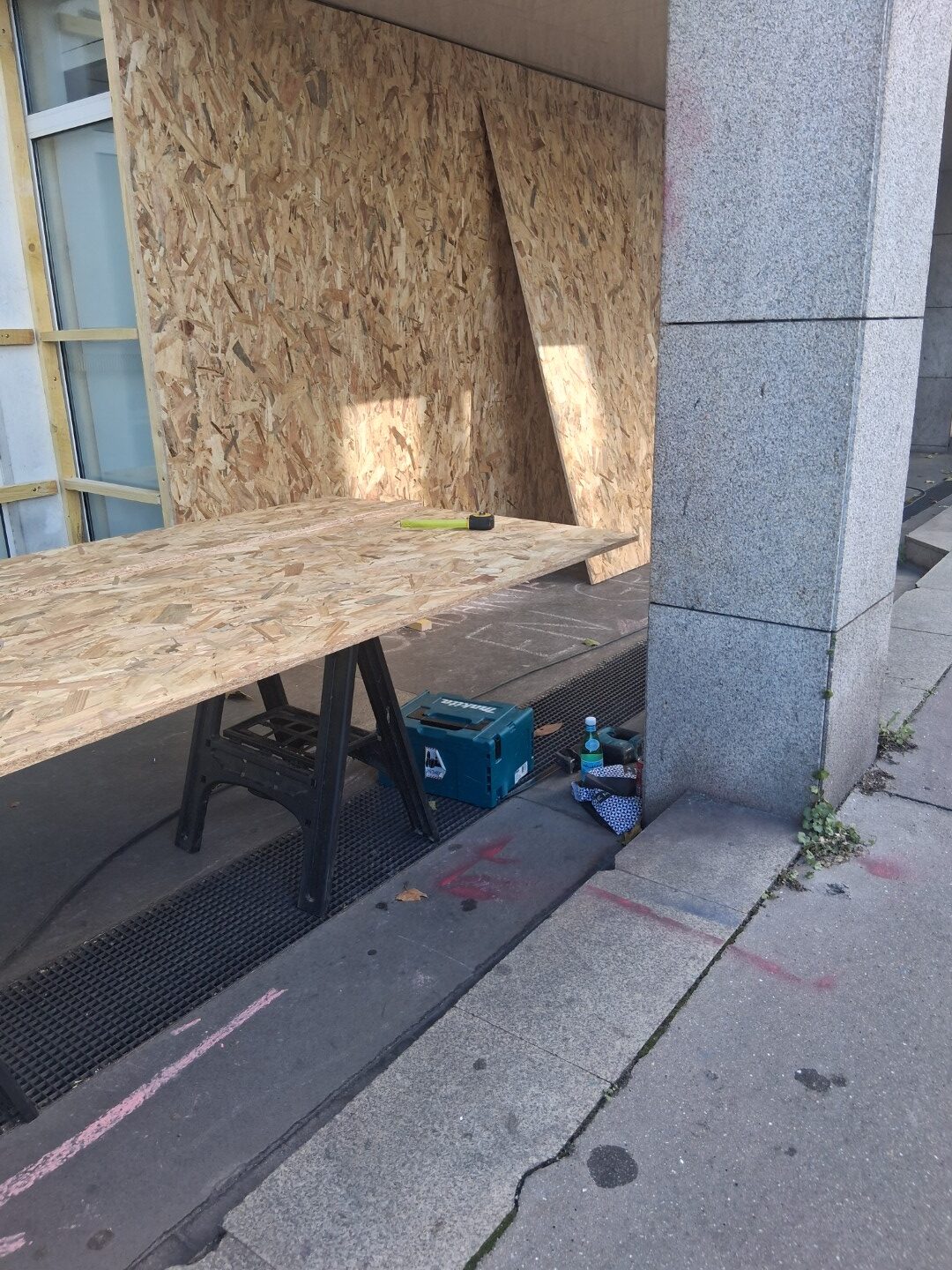 Workers boarding up a storefront — Oct. 22, 2026, Nantes, Pays de la Loire, France