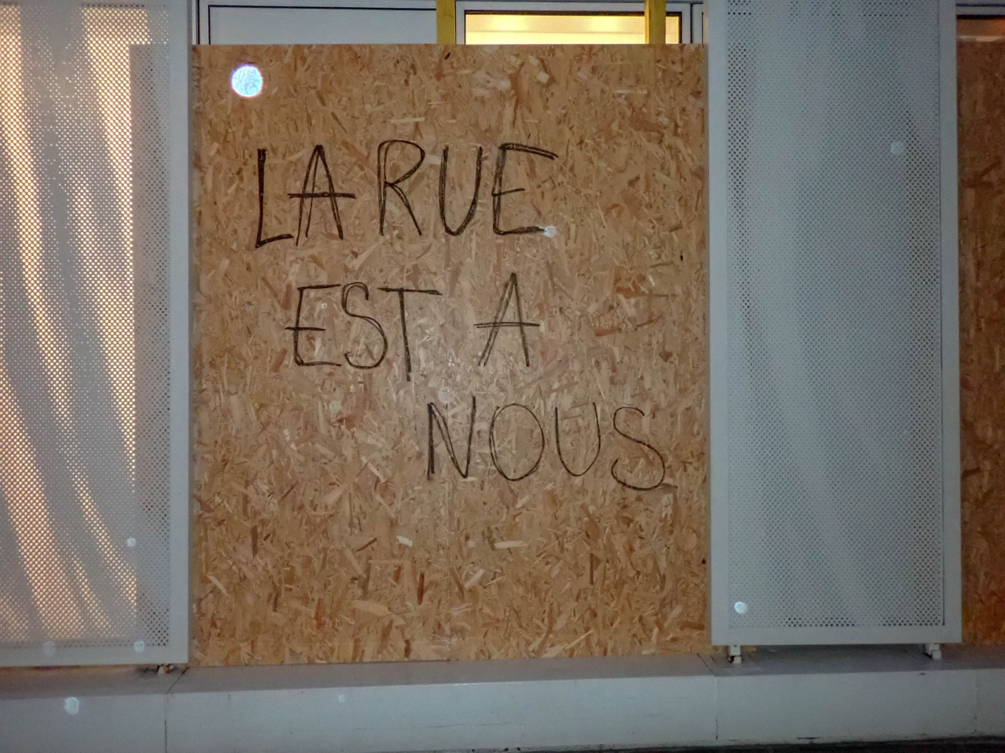 La rue est à nous (The streets are ours), written across a boarded-up window — Oct. 24, 2026, Nantes, Pays de la Loire, France